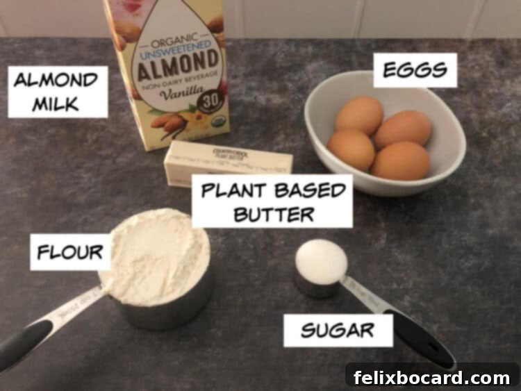 Luscious Dairy Free Almond Milk Crepes 3 A collection of essential ingredients for making dairy-free crepes: a carton of almond milk, a stick of plant-based butter, fresh eggs, a bag of all-purpose flour, and a bowl of sugar, all arranged on a clean kitchen surface.