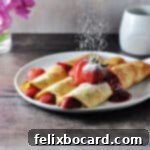 Luscious Dairy Free Almond Milk Crepes 7 golden brown almond milk crepes with fruit being dusted with powdered sugar