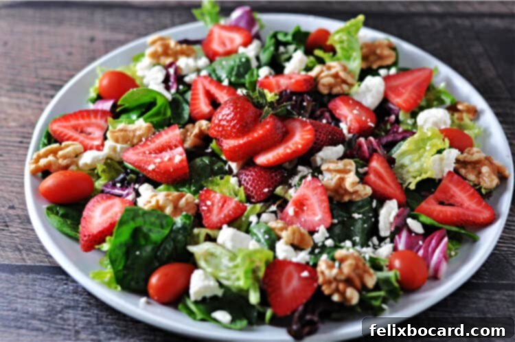 close-up view of a strawberry walnut salad on a plate, showcasing fresh ingredients