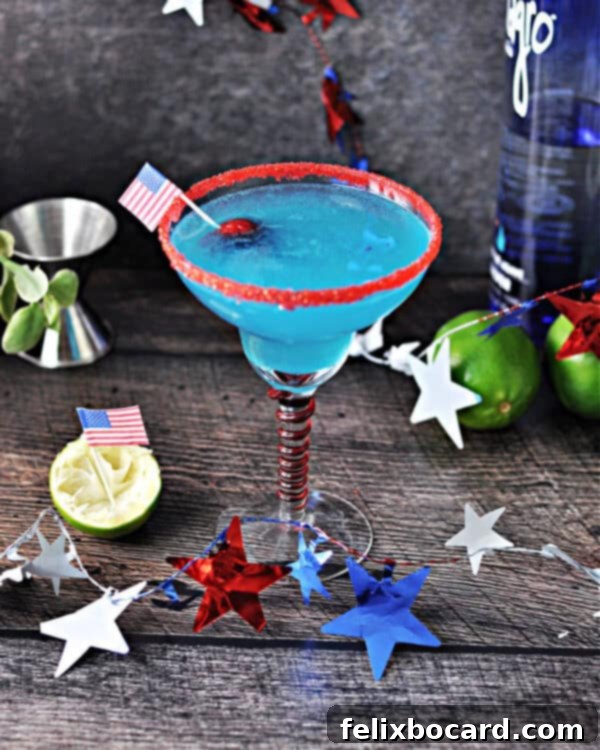 Firecracker Margarita ready to sip, showcasing its vibrant blue color and red rim