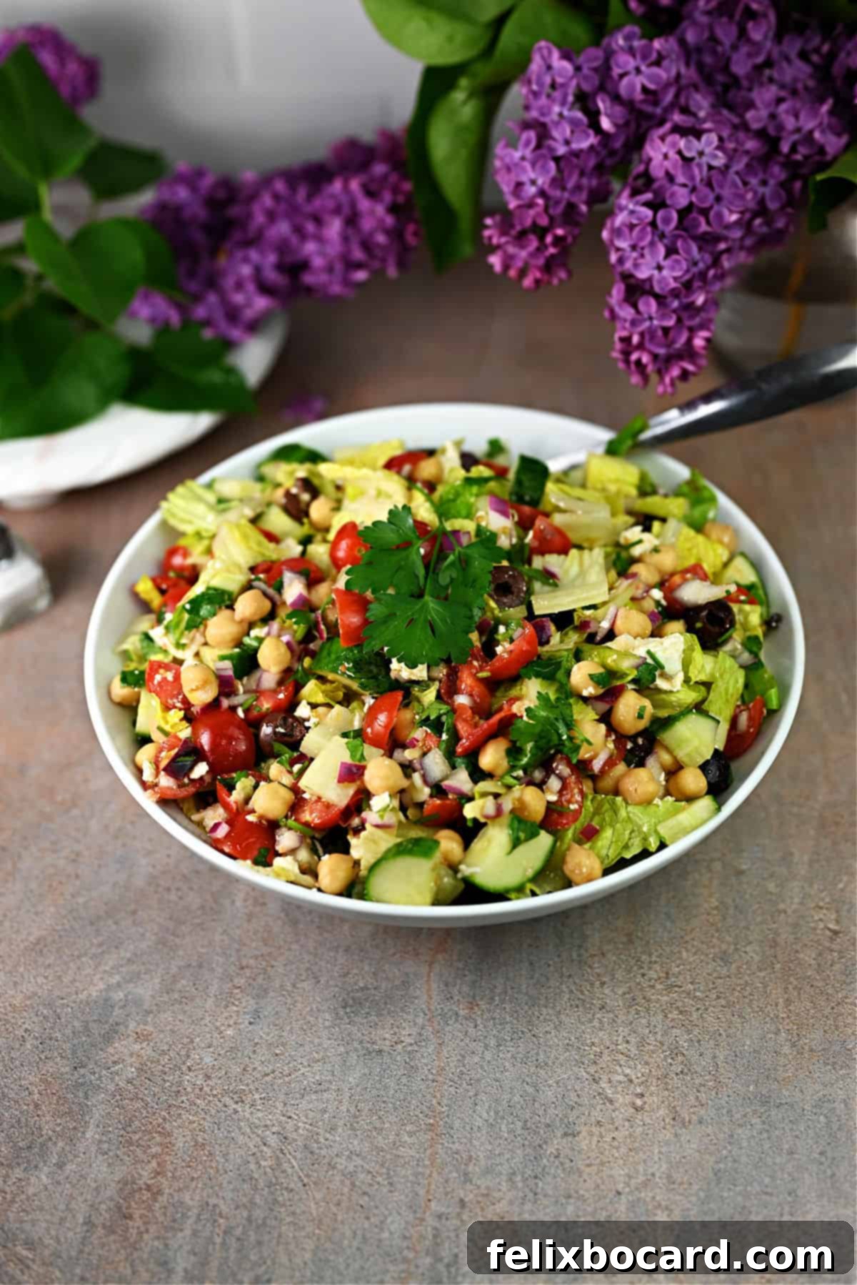 A vibrant serving bowl overflowing with Mediterranean chopped salad, perfectly tossed and ready to be enjoyed as a healthy and flavorful meal.