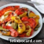 Sweet and Smoky Grilled Peppers and Onions 6 grilled bell peppers and onions on a white plate