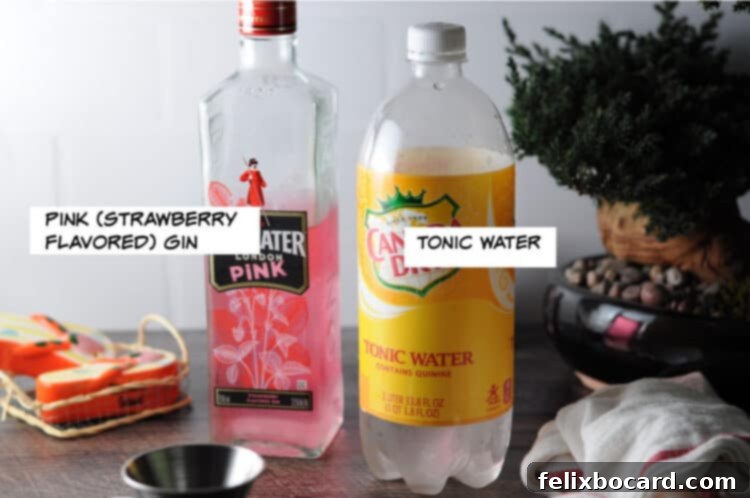 A flat lay photograph showcasing the ingredients for a pink gin and tonic: a bottle of pink gin, a bottle of tonic water, fresh strawberries, and ice.