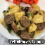 Cheesy Bratwurst Casserole on a plate with carrots