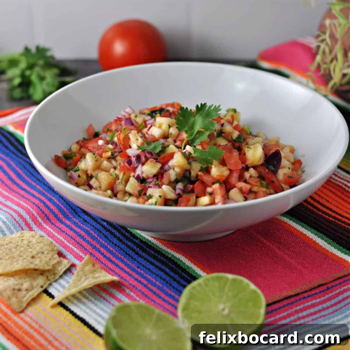 Tropical Heat Salsa 7 Pineapple Habanero Salsa in an elegant serving bowl, placed on a colorful Mexican table runner, ready to be enjoyed.