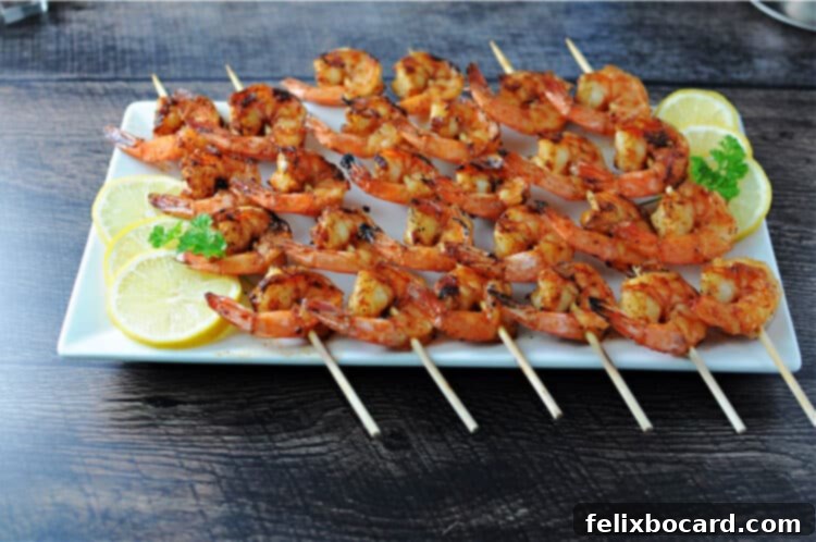 cajun shrimp skewers on a white rectangular platter
