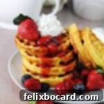 stack of keto breakfast waffles chaffles with fruit.