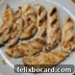 Chargrilled Chicken Strips 9 Close up of perfectly grilled chicken tenders, showing their crispy exterior and juicy texture.