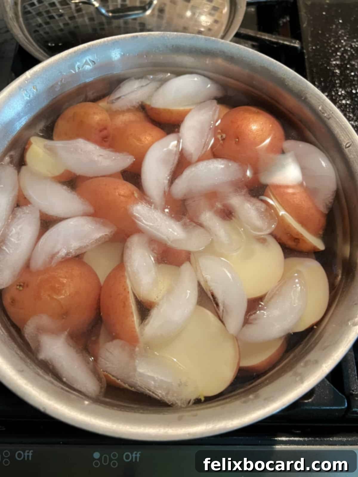 Creamy Red Potato Salad 7 Cooked potatoes and eggs cooling in ice water.