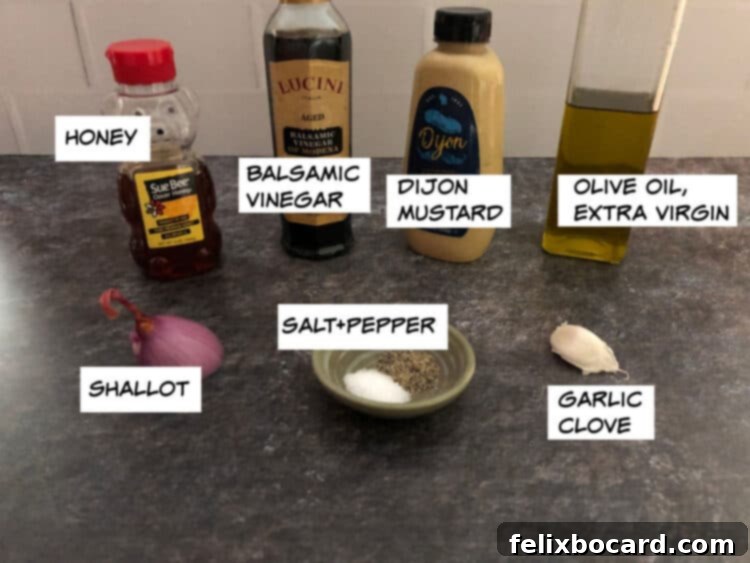 Elevate Your Salad with Homemade Balsamic Vinaigrette 3 A vibrant flat lay of fresh ingredients for balsamic vinaigrette: glistening honey, rich balsamic vinegar, creamy Dijon mustard, golden olive oil, finely diced shallot, whole garlic cloves, and sprinklings of salt and pepper.