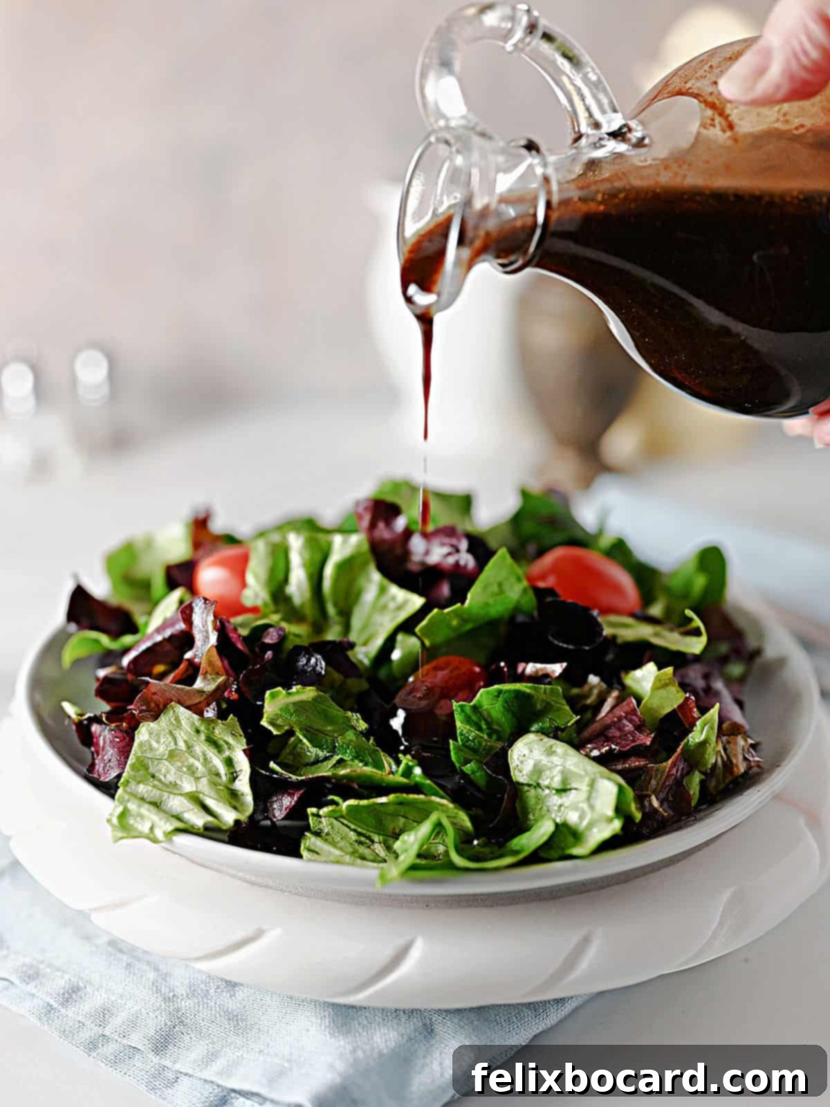 Elevate Your Salad with Homemade Balsamic Vinaigrette 9 A stream of homemade balsamic vinaigrette dressing gracefully pouring over a fresh green salad, highlighting its perfect consistency.