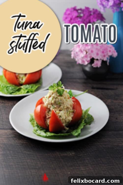Pinterest pin image for tuna stuffed tomato, featuring a close-up of the dish on a plate.
