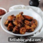 Air fryer BBQ chicken wings in a shallow white bowl