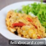 chicken fajita casserole on a plate with salad.