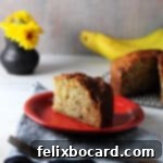 Golden Air Fryer Banana Bread 10 A delicious slice of air fryer banana bread on a small red plate.