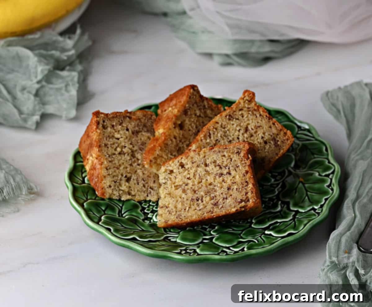 Golden Air Fryer Banana Bread 5 Golden brown slices of air fryer banana bread neatly arranged on a small green plate, highlighting its perfect texture.