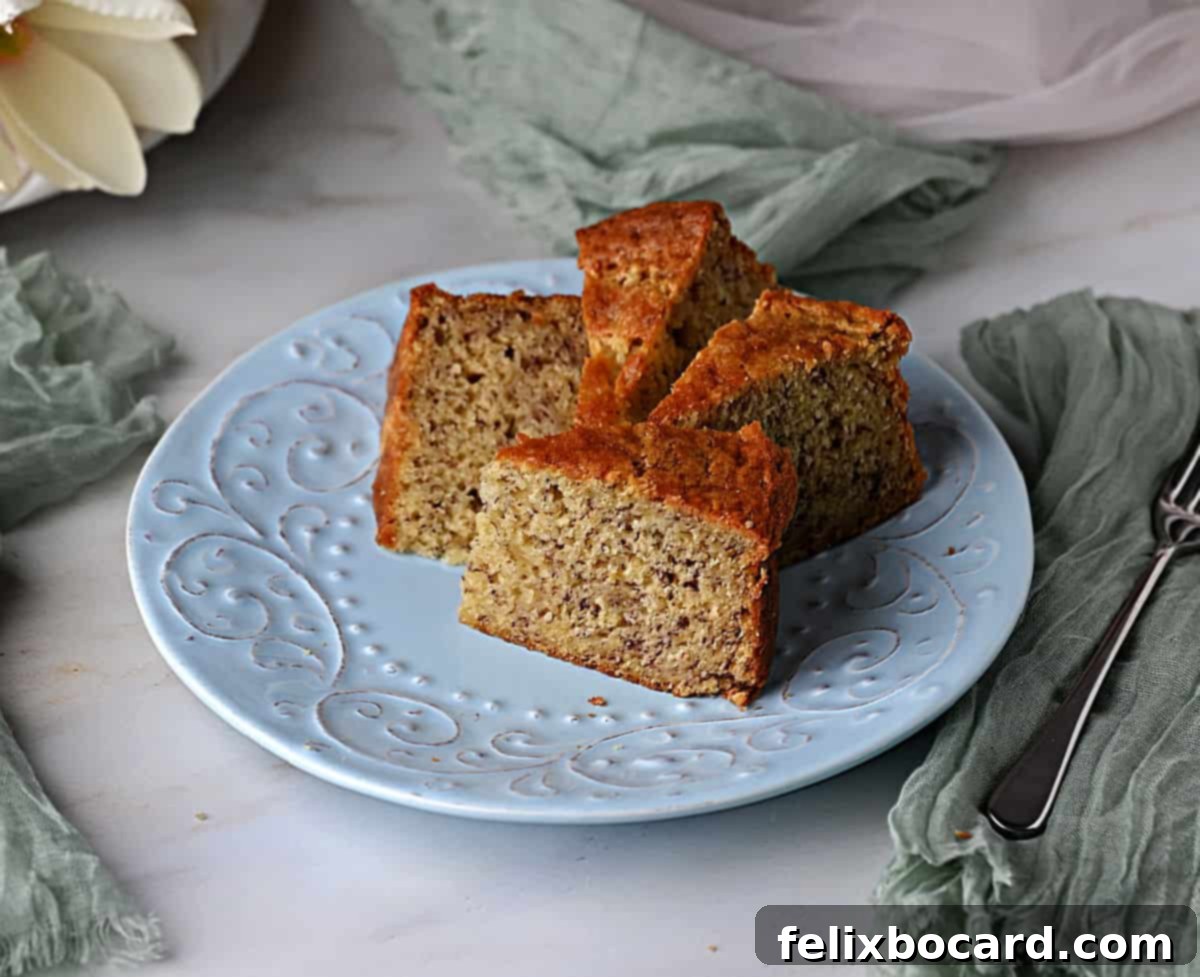 Golden Air Fryer Banana Bread 6 Neatly cut pieces of air fryer banana bread, perfectly stacked on a light blue plate, inviting you to enjoy this delicious treat.