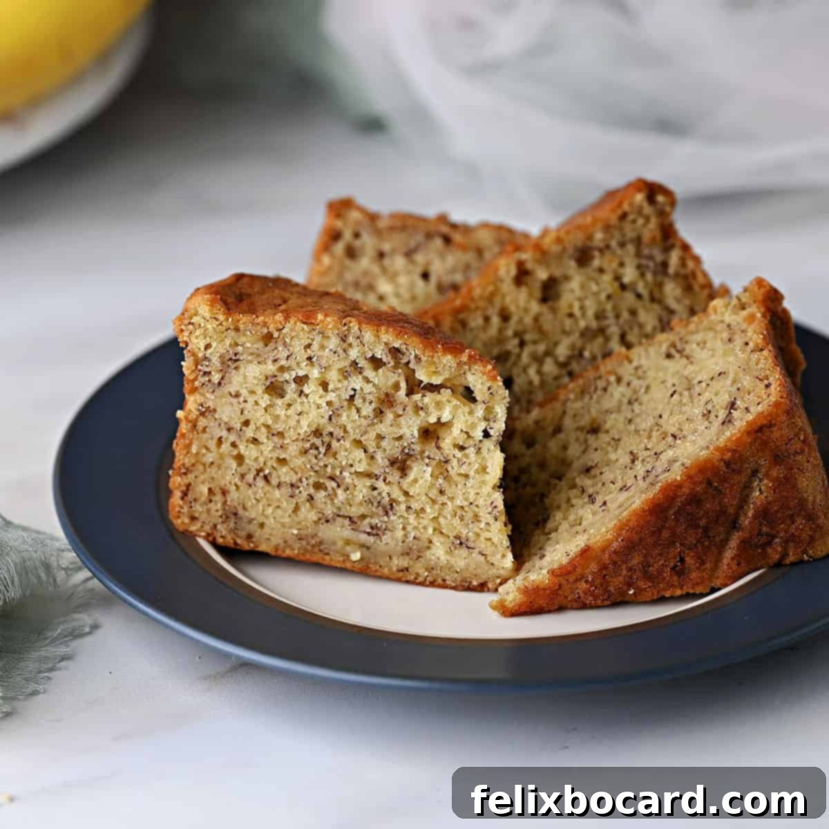 Golden Air Fryer Banana Bread 9 Several slices of air fryer banana bread arranged on a small plate, ready for serving or snacking.