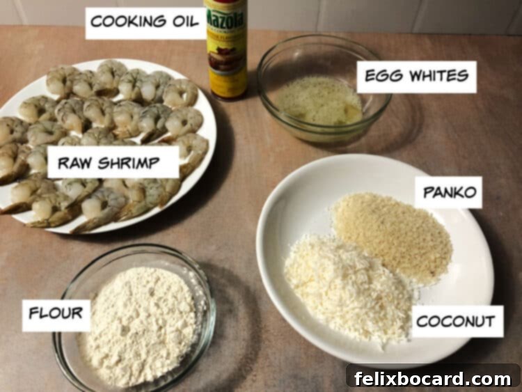 Crispy Air Fryer Coconut Shrimp 3 Ingredients for Air Fryer Coconut Shrimp laid out: raw shrimp, cooking oil spray, egg whites, panko bread crumbs, shredded coconut, and all-purpose flour