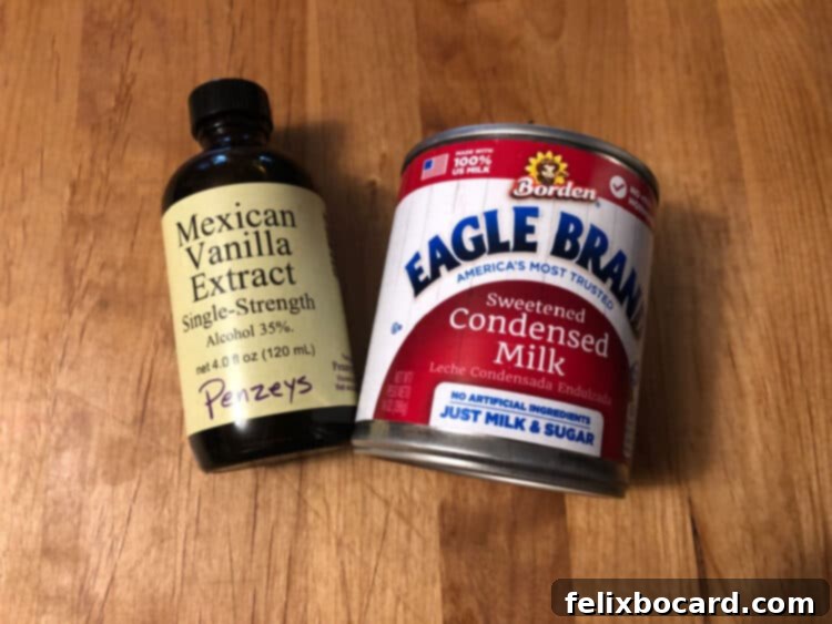 Instant Pot Dulce de Leche 3 Vanilla extract bottle next to a can of sweetened condensed milk, showing the two simple ingredients.