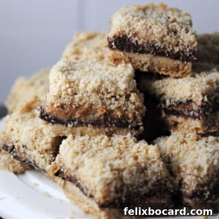 Stack of freshly baked Chocolate Caramel Pecan Bars on a plate