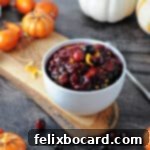 Low-Carb Cranberry Delight 6 a bowl of sugar free keto cranberry sauce surrounded by decorations with a spoon nearby