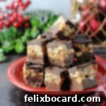 Snickers fudge piled on a small red plate, surrounded by holiday decor