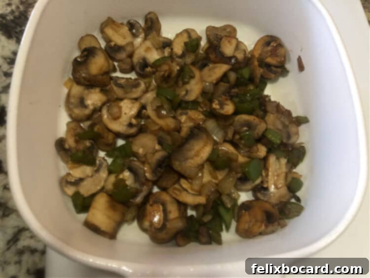 Keto Breakfast Casserole with Spinach, Bacon, and Eggs 4 cooked veggie layer in baking dish