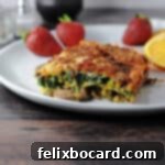 Keto Breakfast Casserole with Spinach, Bacon, and Eggs 10 Low Carb breakfast casserole on a white plate with fruit