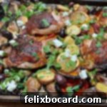 Sheet pan Mediterranean chicken dinner, garnished and ready to serve.