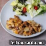 hamburger potato casserole served on a plate with a salad