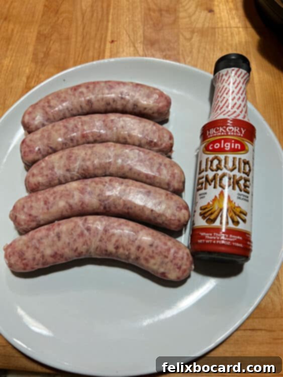 Raw sausages and a bottle of liquid smoke, the ingredients for air fryer brats.