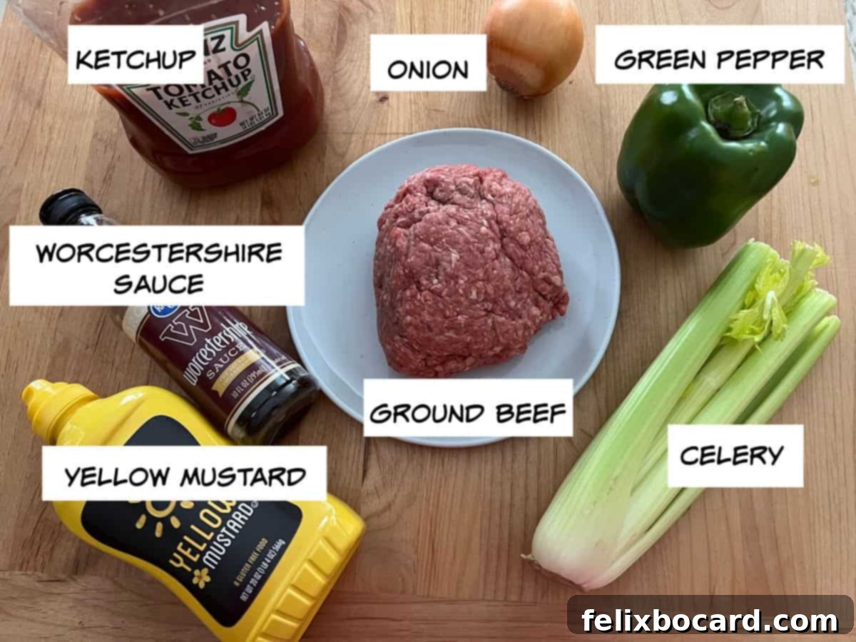A selection of fresh ingredients laid out on a cutting board: ketchup, worcestershire sauce, yellow mustard, a whole onion, a green bell pepper, a stalk of celery, and a package of ground beef.