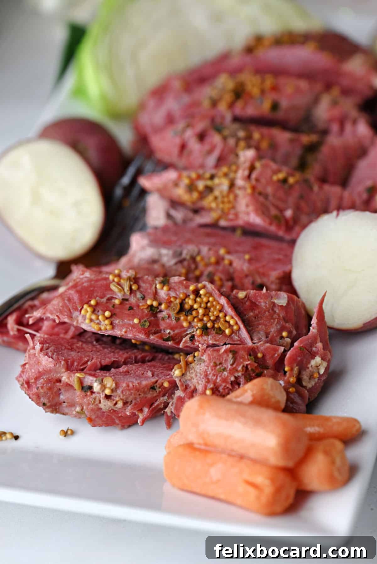 Instant Pot Corned beef sliced on a platter with veggies.