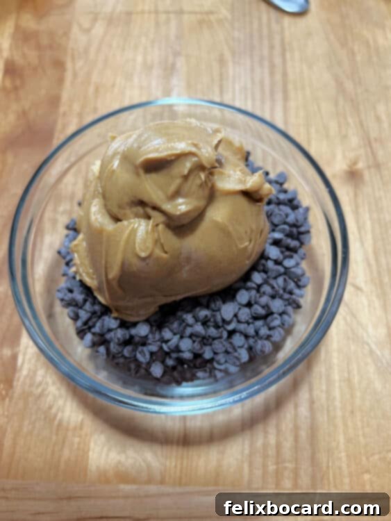 Semi-sweet chocolate chips and creamy peanut butter in a microwave-safe glass bowl.