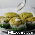 spoon drizzling some glaze on a green tea muffin