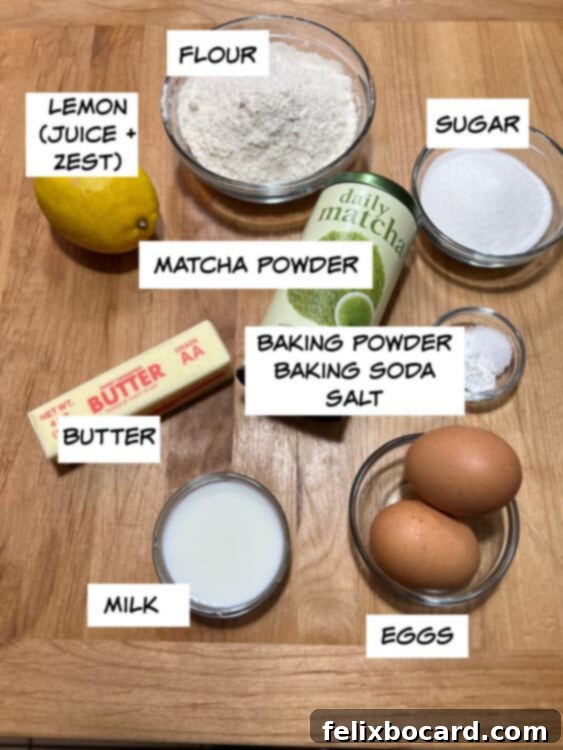 Collection of fresh ingredients for green tea muffins: vibrant lemons, all-purpose flour, granulated sugar, high-quality matcha powder, baking powder, baking soda, coarse salt, fresh eggs, whole milk, and unsalted butter.