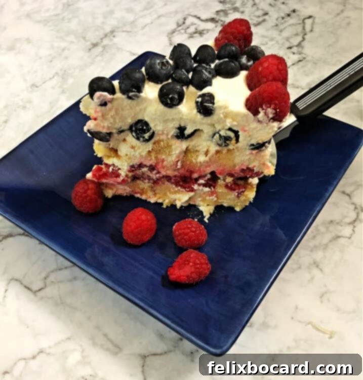 slice od frozen patriotic torte on a blue plate showing the layers