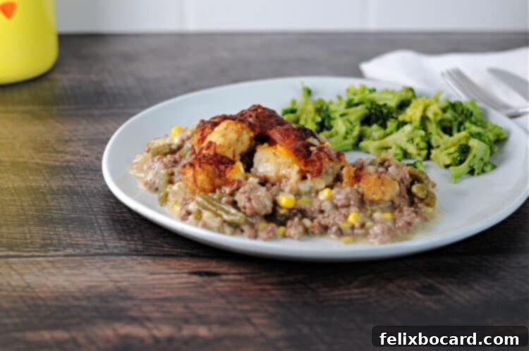 serving of instant pot tater tot casserole on a plate with broccoli.