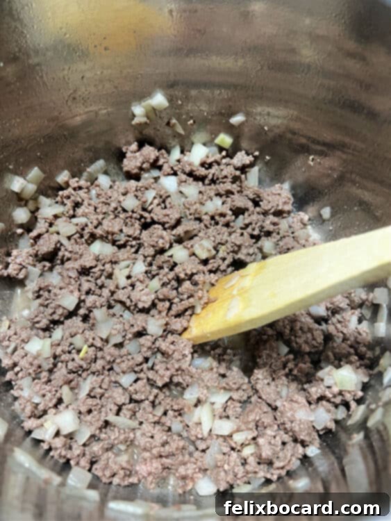 ground beef and onions browning in teh Instant Pot on saute function.