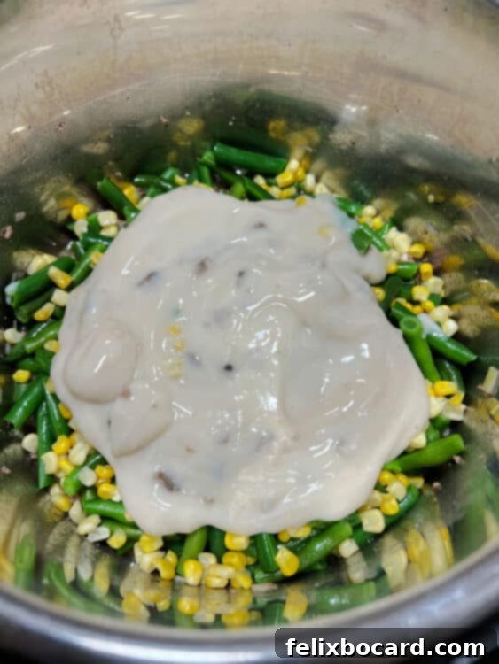 veggies and soup layered on top the beef mixture in instant pot.