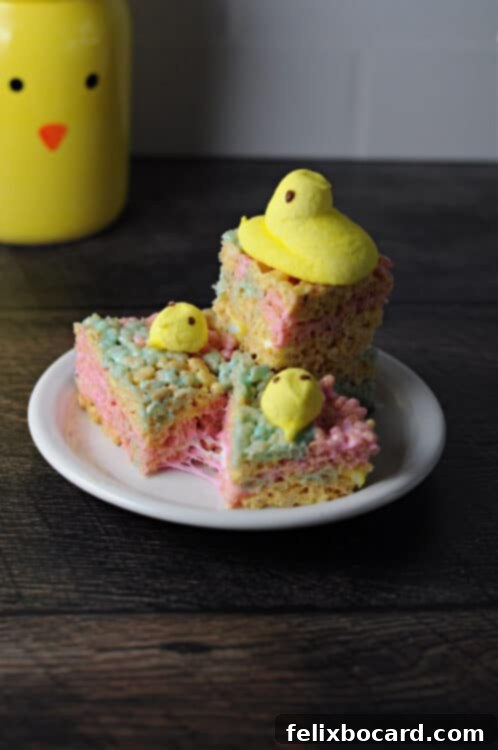 3 peeps rice krispie treats on a plate, decorated with more peeps chicks.