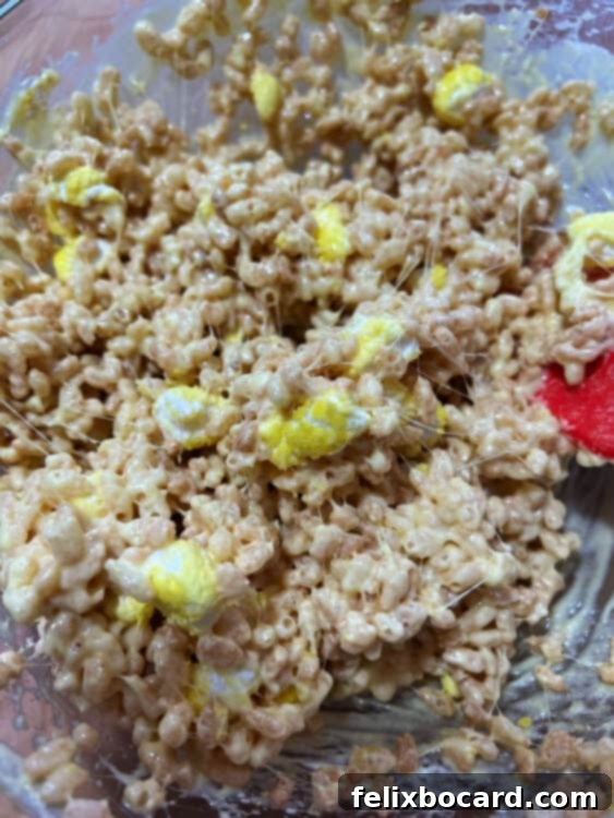 adding in cut up Peeps to the cereal mixture.