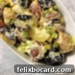 Red, white, and blue potato salad in a serving bowl