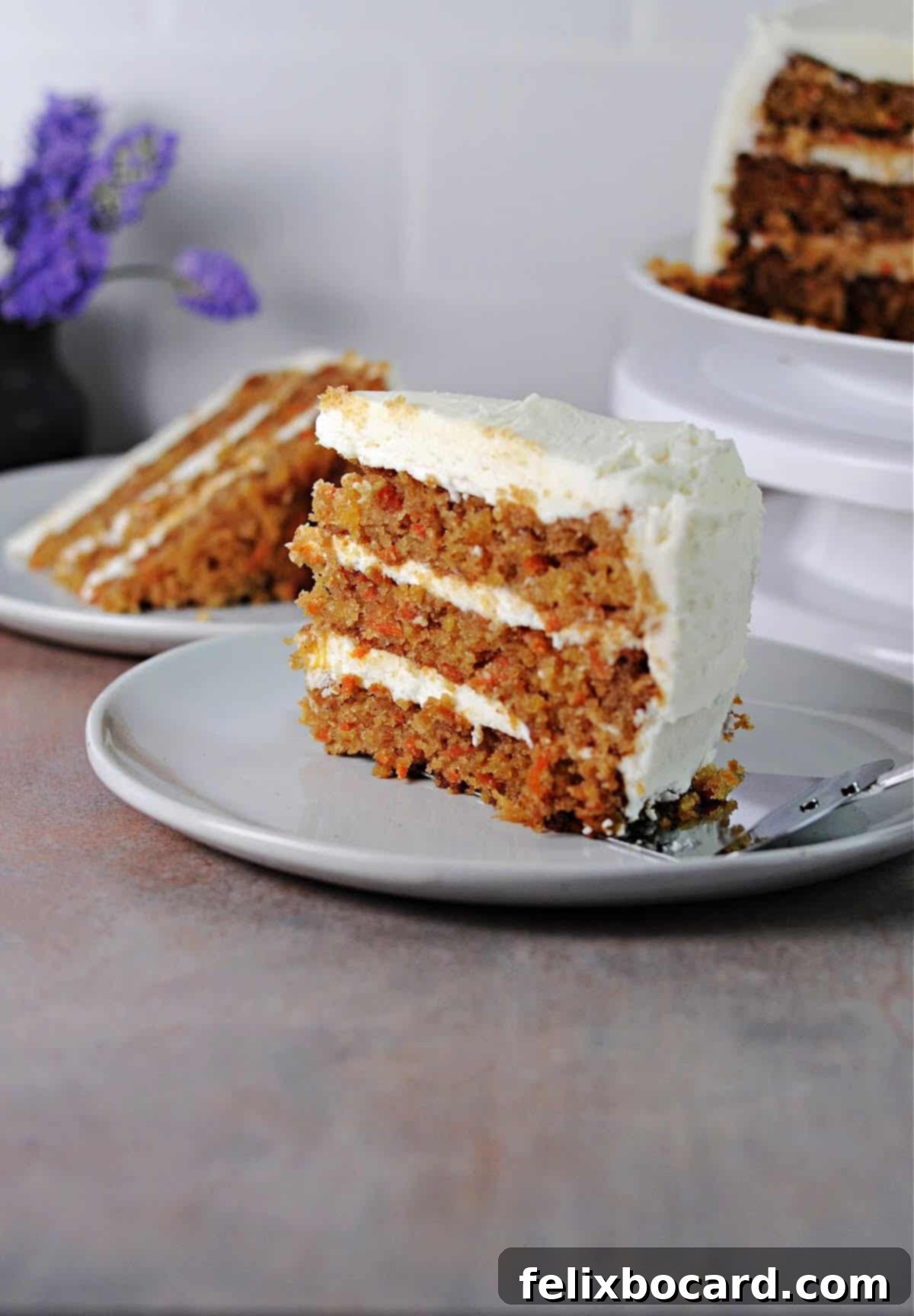 old fashioned carrot cake served on a small white plate.
