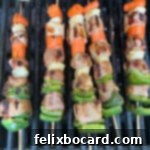 Sweet and sour pork kabobs cooking on the grill.