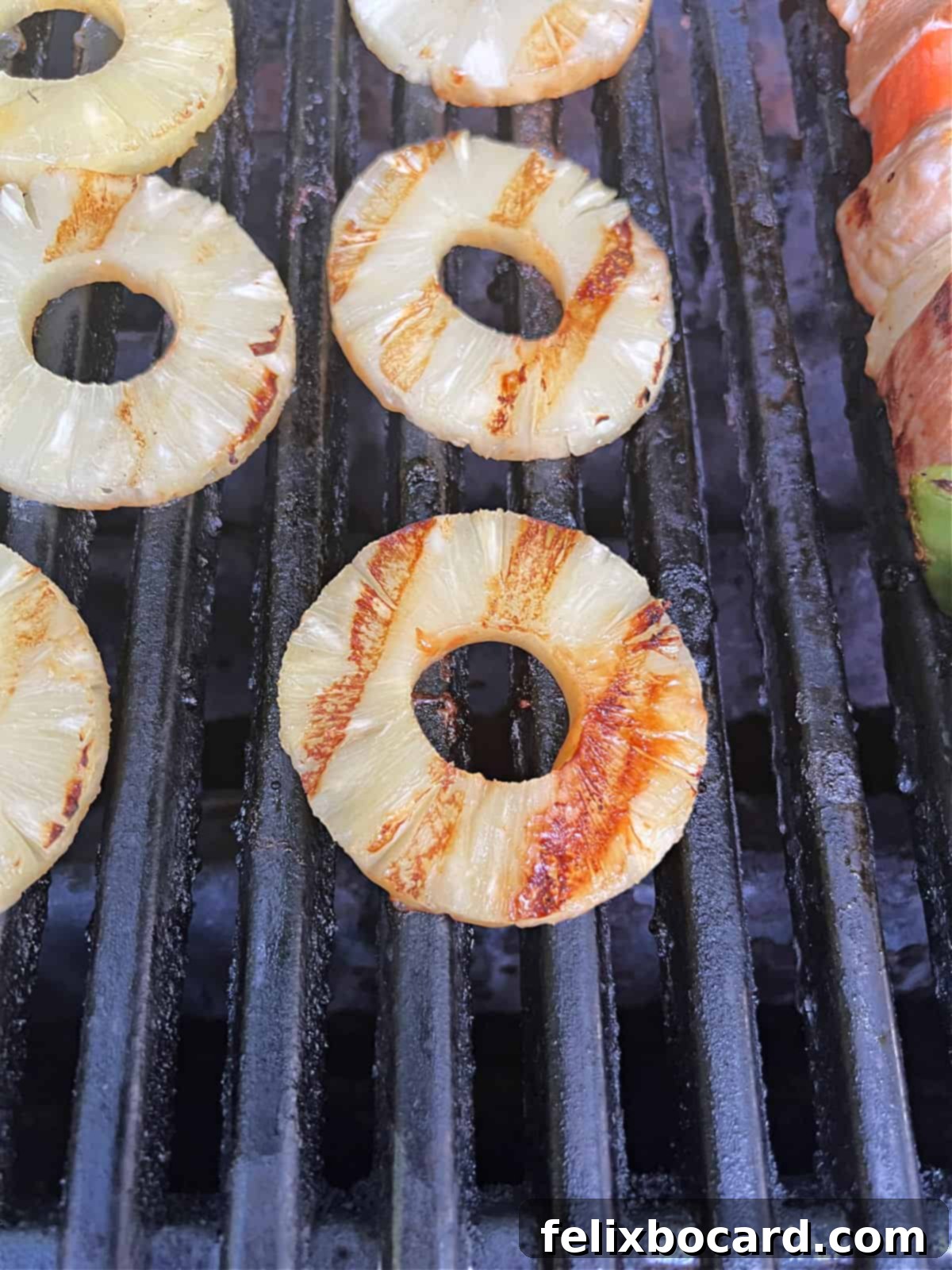 Pineapple slices cooking beautifully on the grill grates.