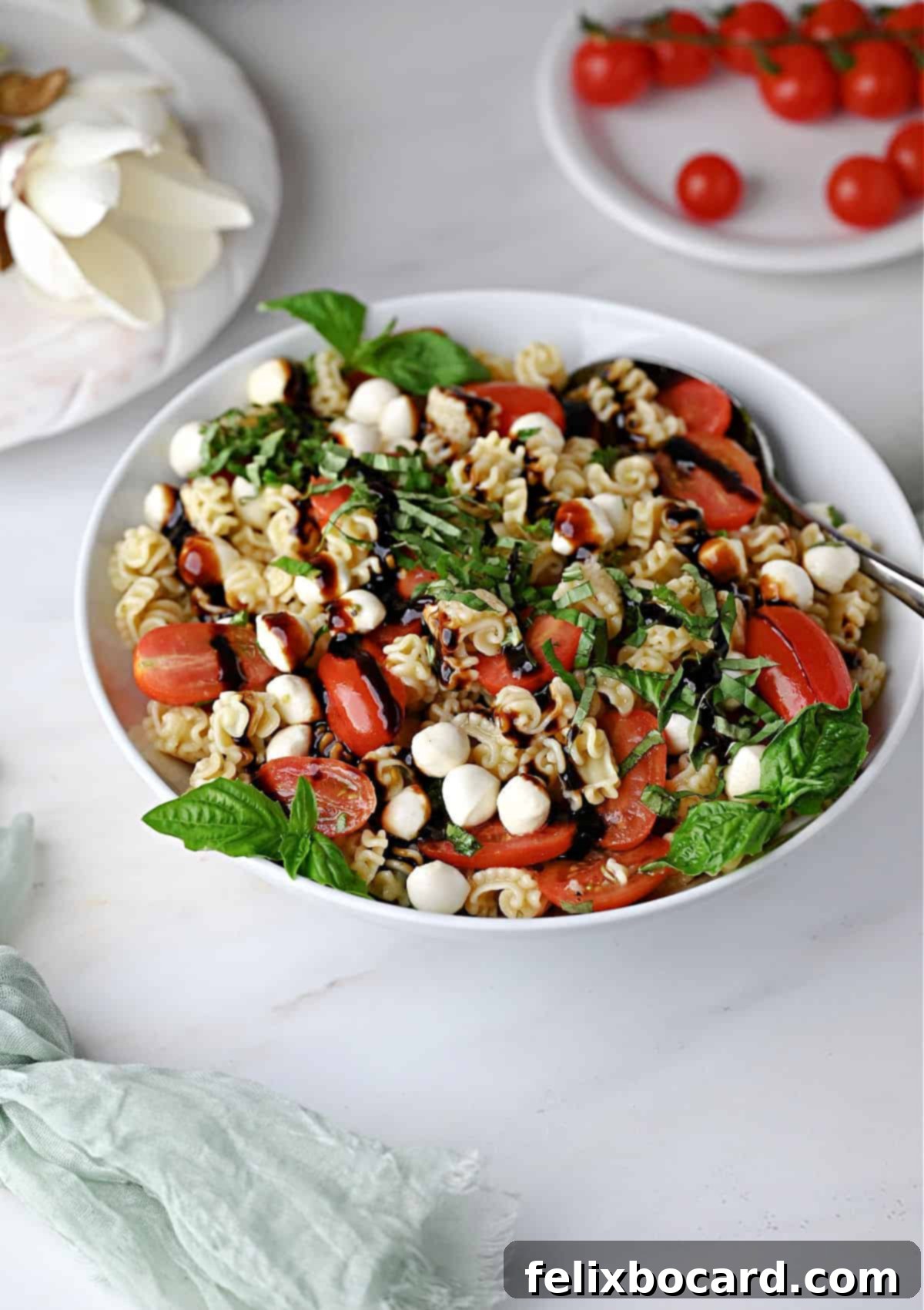 A complete Caprese pasta salad in a serving bowl, perfectly garnished and ready.