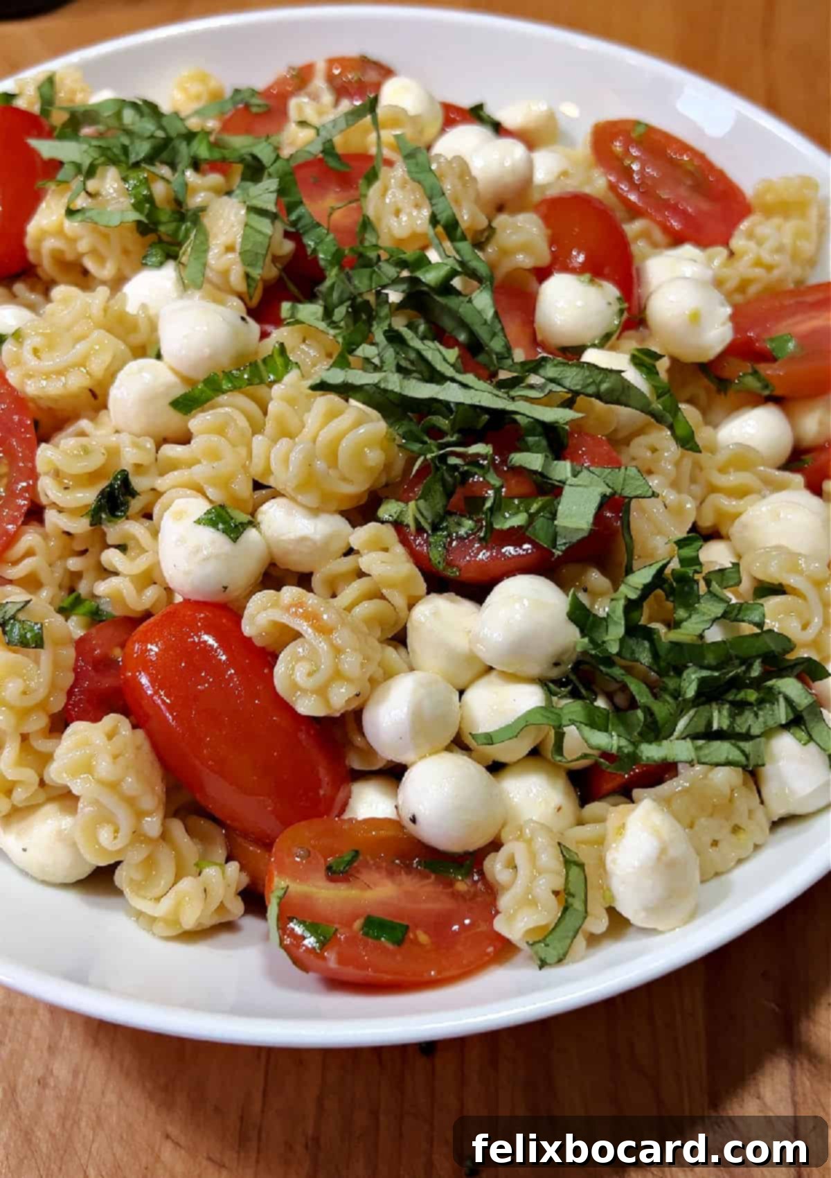 Assembled pasta salad in a bowl, before the final balsamic drizzle.
