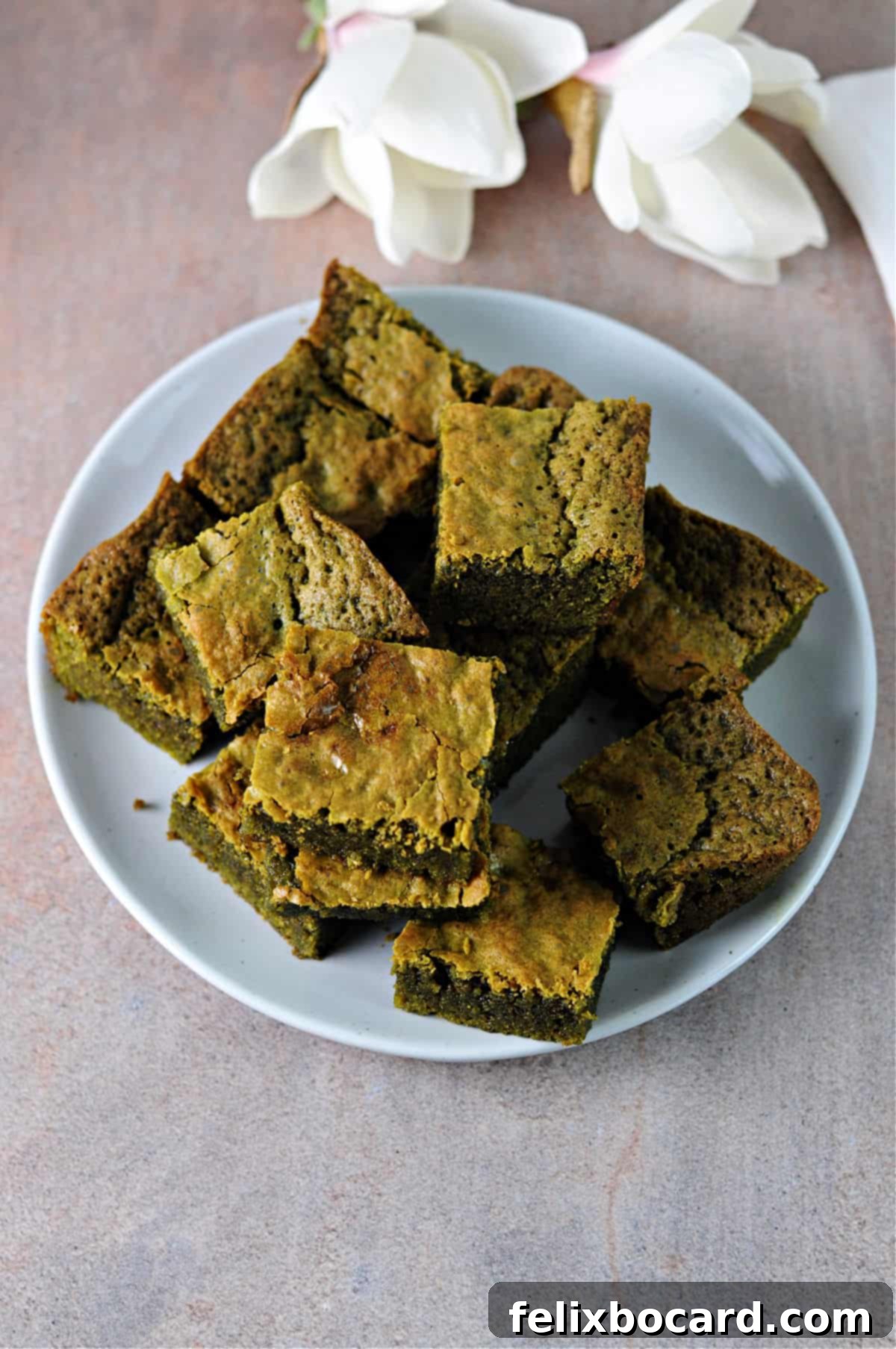 Top down view of a plate of matcha brownies.